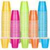 A collection of colorful disposable plastic shot cups in yellow, pink, green, and blue stacked vertically.