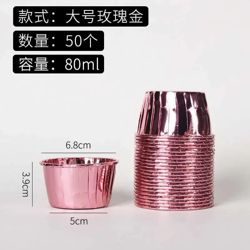 A stack of 50 pink metallic cupcake liners, each measuring 80ml, is shown next to a measuring scale.