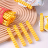 A collection of yellow, fry-shaped sealing clips is displayed on a wooden board next to a package of fries.