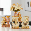 Gold ceramic swan vase for tabletop decor with floral accents