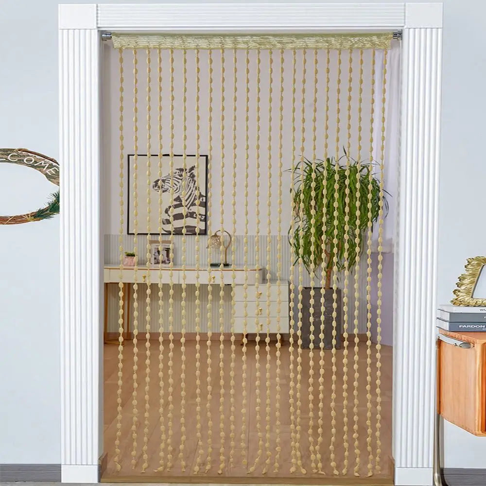 Elegant beaded string curtain with tassels used as a bohemian drape for a door or window.