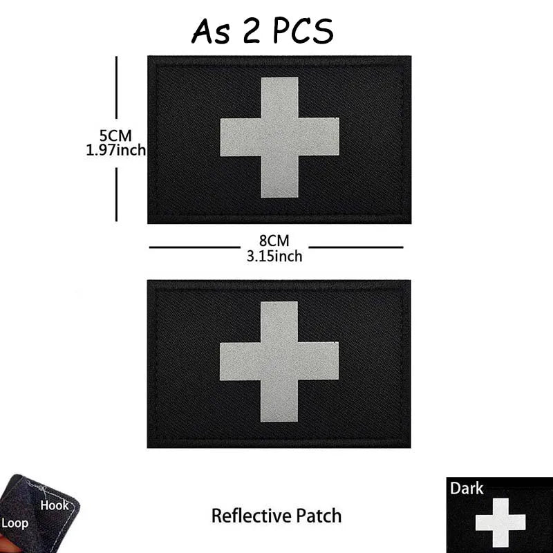 Two black reflective patches with silver crosses, measuring 5cm by 8cm each.