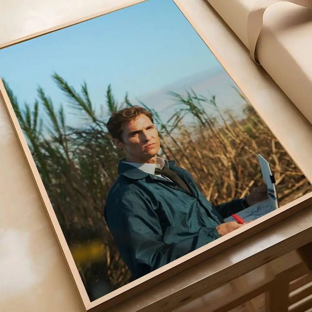 A movie poster featuring a man in a dark coat against a natural, grassy background, displayed in a framed piece of wall art.