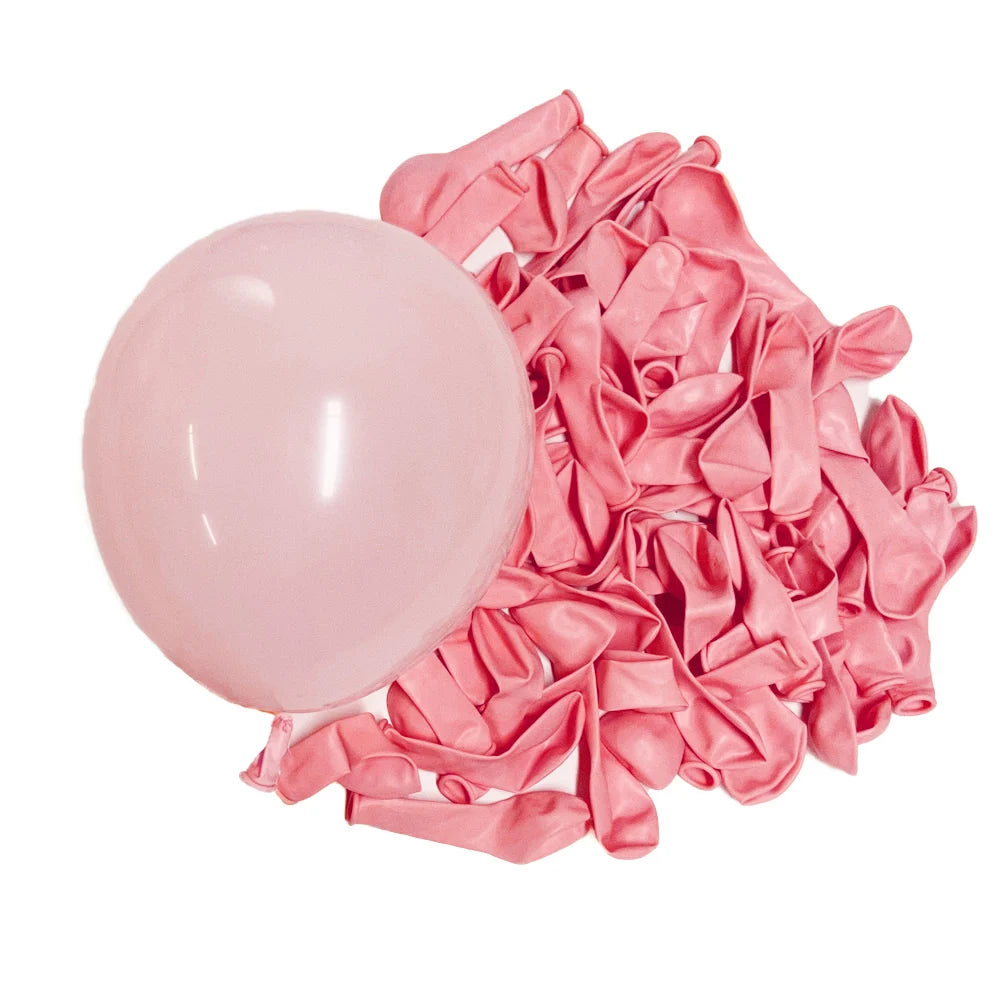 A pile of pink pastel macaron latex balloons for parties and celebrations.