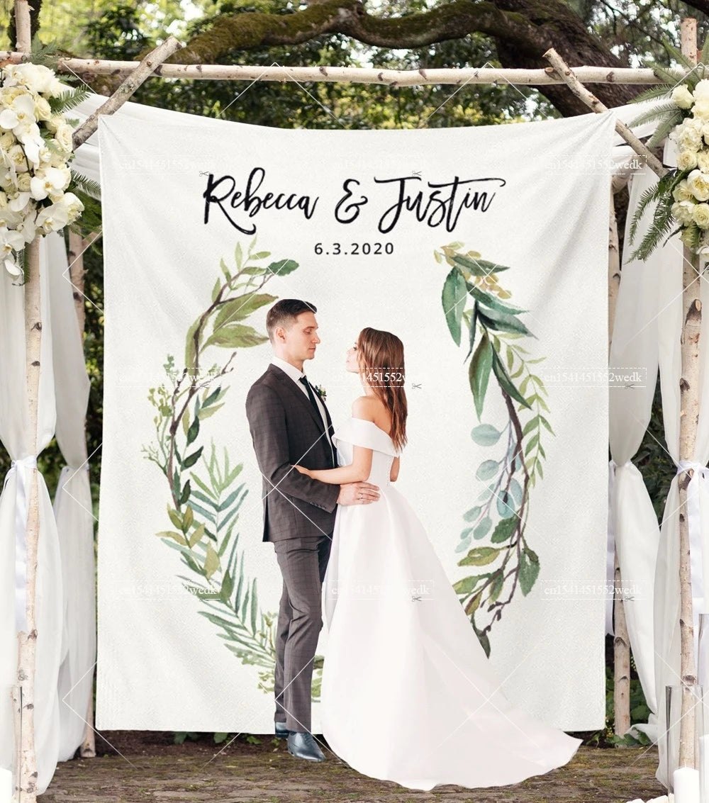 A wedding photo tapestry featuring a bride and groom standing in an outdoor setting surrounded by greenery.