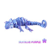 A blue-purple articulated 3D printed dragon lizard figurine.