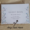 A white guest book card with floral borders and text for Mr & Mrs Davies wedding on June 17th, 2023.