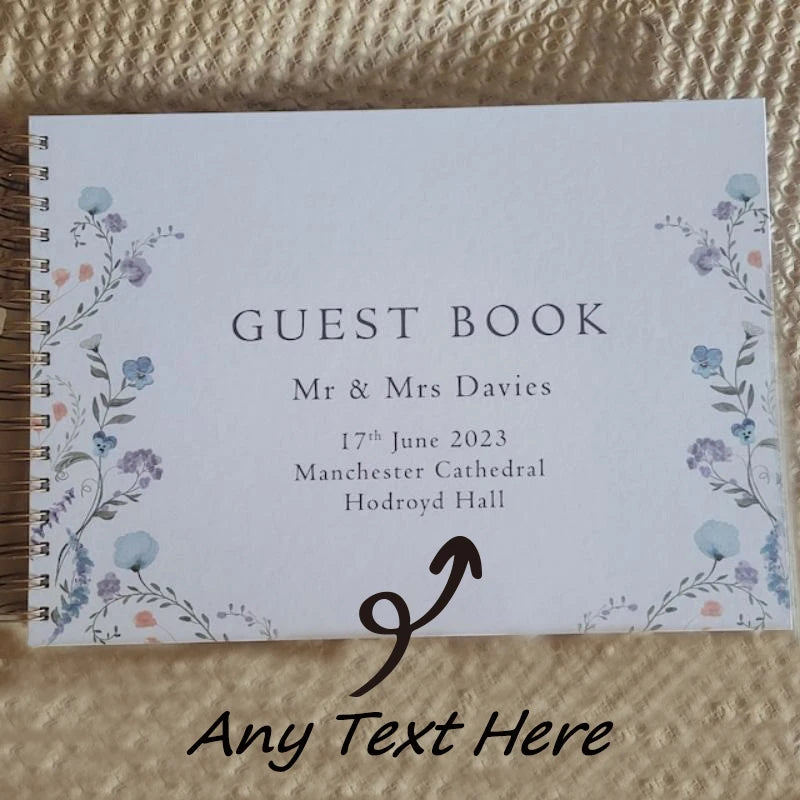 A white guest book card with floral borders and text for Mr & Mrs Davies wedding on June 17th, 2023.