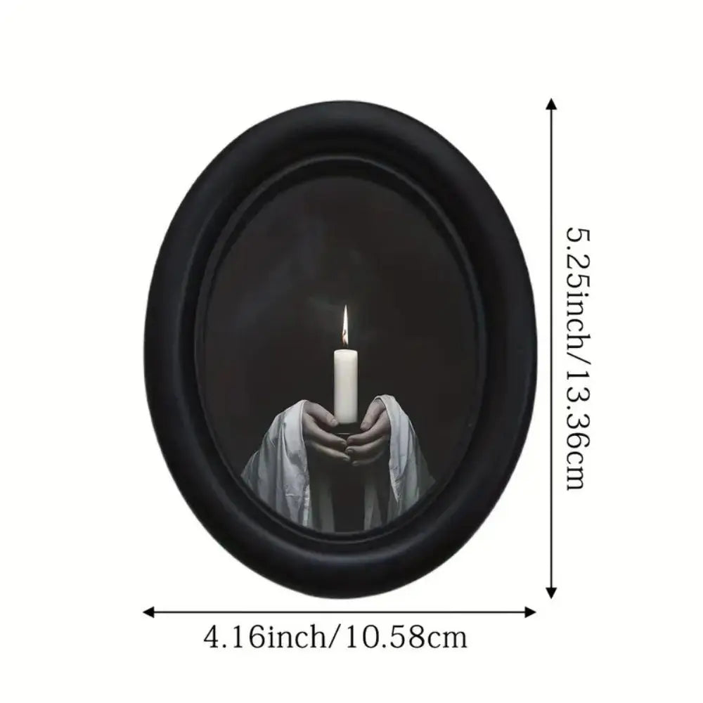A black oval frame containing a lit white candle, used as wooden wall art.