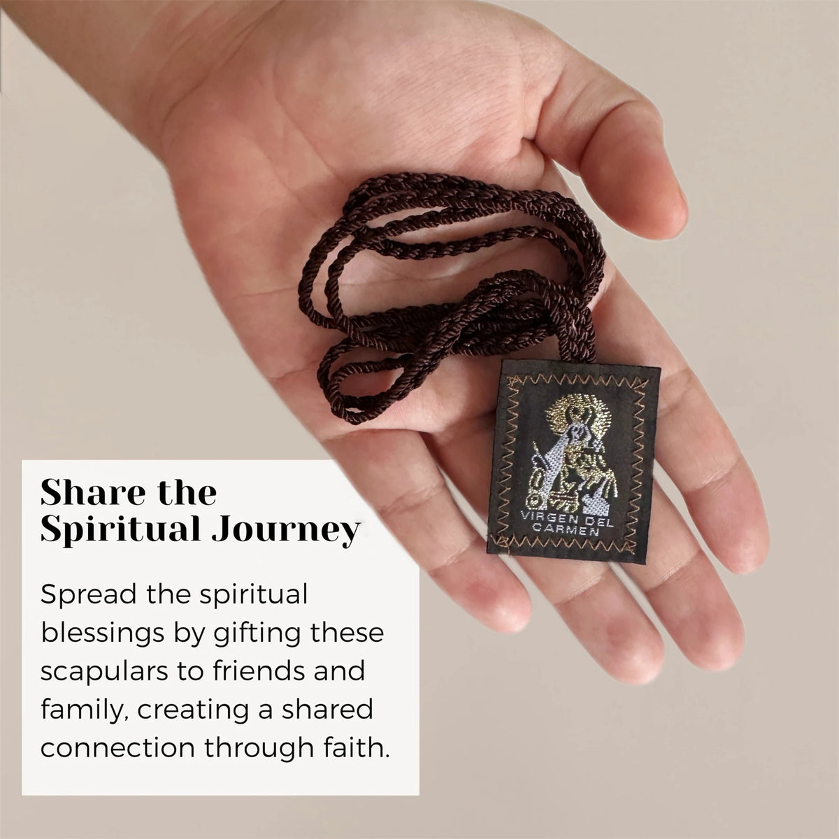 A hand holds a dark brown cord necklace set with Catholic symbols and a small card, illustrating sharing spiritual blessings.