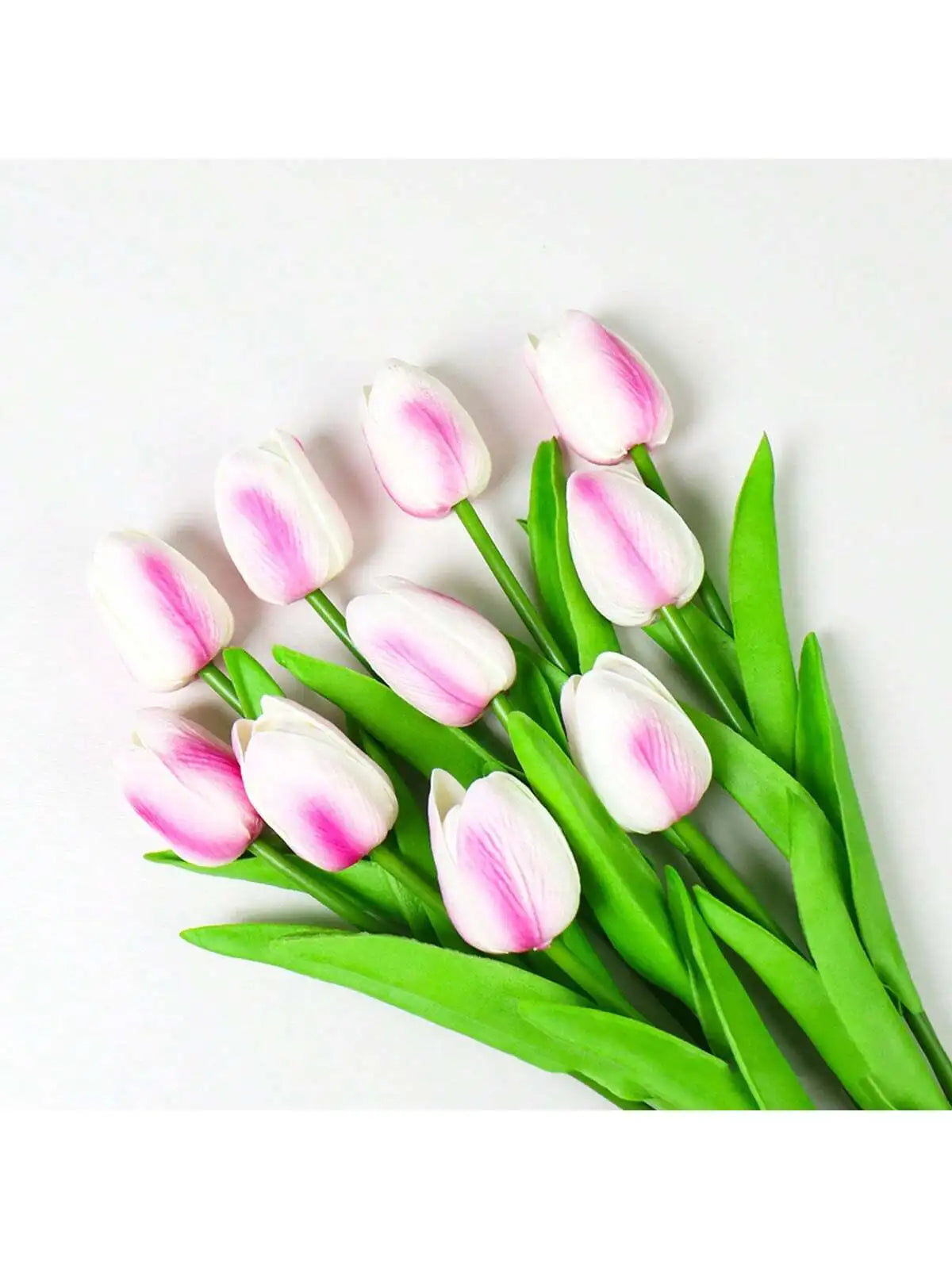A set of six pink and white artificial tulips with green stems displayed on a white background.