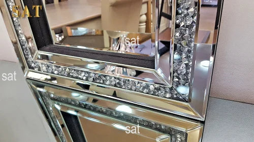 A silver crystal beveled wall mirror with a reflective frame and dark trim.