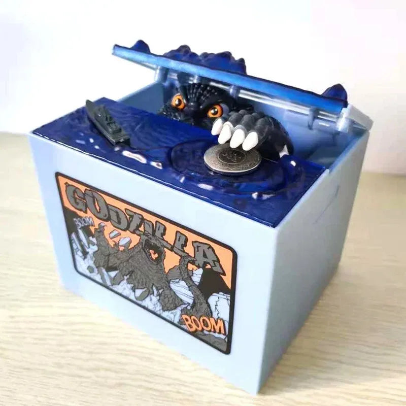 A blue resin piggy bank shaped like Godzilla with a detailed Godzilla figure inside.