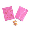 Pink foil zip bags containing several pills or capsules.