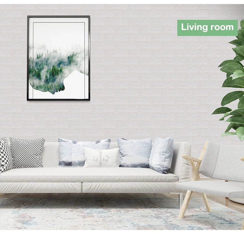 A living room decorated with a white sofa, light rug, and a framed watercolor painting of misty green landscape.