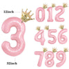 Pink aluminum foil crown number balloons showing the numbers three, four, five, six, seven, eight, and nine.