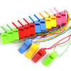 A collection of colorful plastic whistles in various colors attached to lanyards.