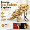 A light beige 3D printed T-Rex skeleton keychain with articulated joints and a chain.