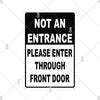 A black warning sign with white text that reads NOT AN ENTRANCE PLEASE ENTER THROUGH FRONT DOOR
