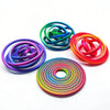 A collection of colorful, flexible rubber bands or rings arranged in various spirals and loops.
