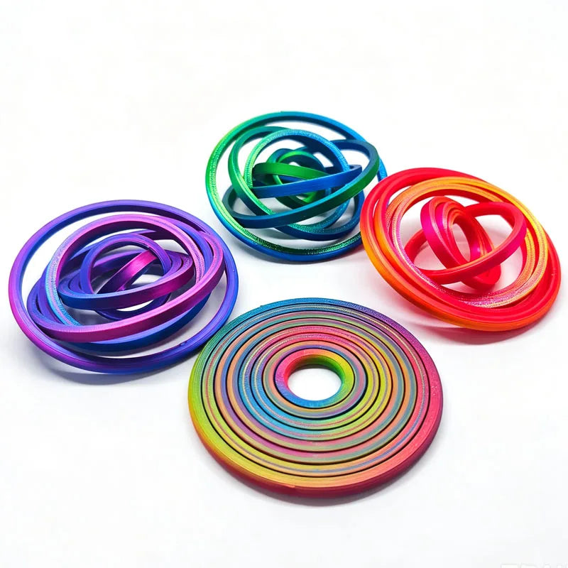 A collection of colorful, flexible rubber bands or rings arranged in various spirals and loops.