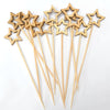 A set of wooden cocktail picks with star tips and a pearl finish, arranged on a white background.
