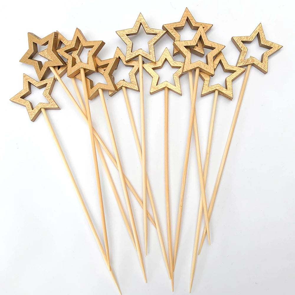 A set of wooden cocktail picks with star tips and a pearl finish, arranged on a white background.