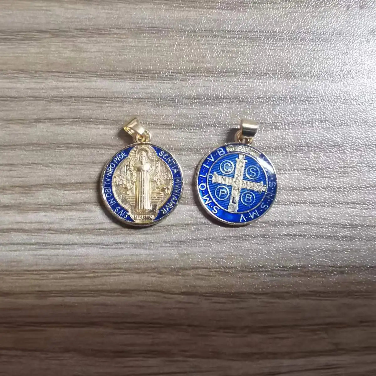 A pair of silver and blue religious pendants featuring St. Benedict symbols for crafting or gifting.
