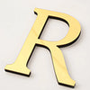 A gold acrylic mirror letter R wall sticker for self-adhesive decor.