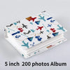 A white album cover featuring colorful cartoon airplane and ship motifs for a 5 inch 200 photos memory album.