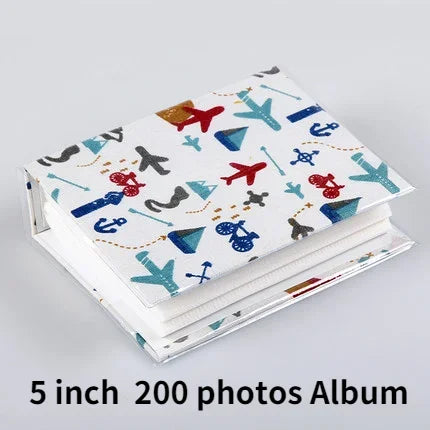 A white album cover featuring colorful cartoon airplane and ship motifs for a 5 inch 200 photos memory album.