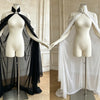A mannequin displays a sheer black chiffon cape with a tie closure, shown against a light background.