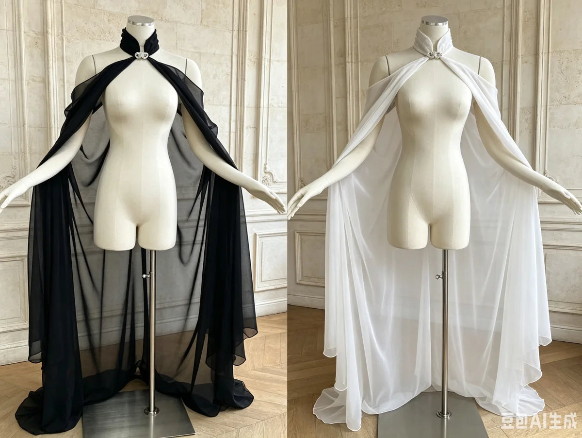 A mannequin displays a sheer black chiffon cape with a tie closure, shown against a light background.