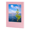 A pink magnetic double-sided frame displaying a scenic view of water and trees under a blue sky.