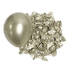 A single metallic silver latex balloon next to a pile of crumpled metallic silver foil balloons.