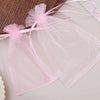Pink organza drawstring gift bags with sheer fabric and pink ribbon