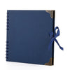Bloc-notes d'album plat bleu foncé avec accents dorés et un ruban bleu marine sur la couverture.