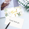 Ein Set eleganter Blumen-Dankeskarten mit Goldakzenten und grünem Laub, präsentiert auf einer weißen Oberfläche.