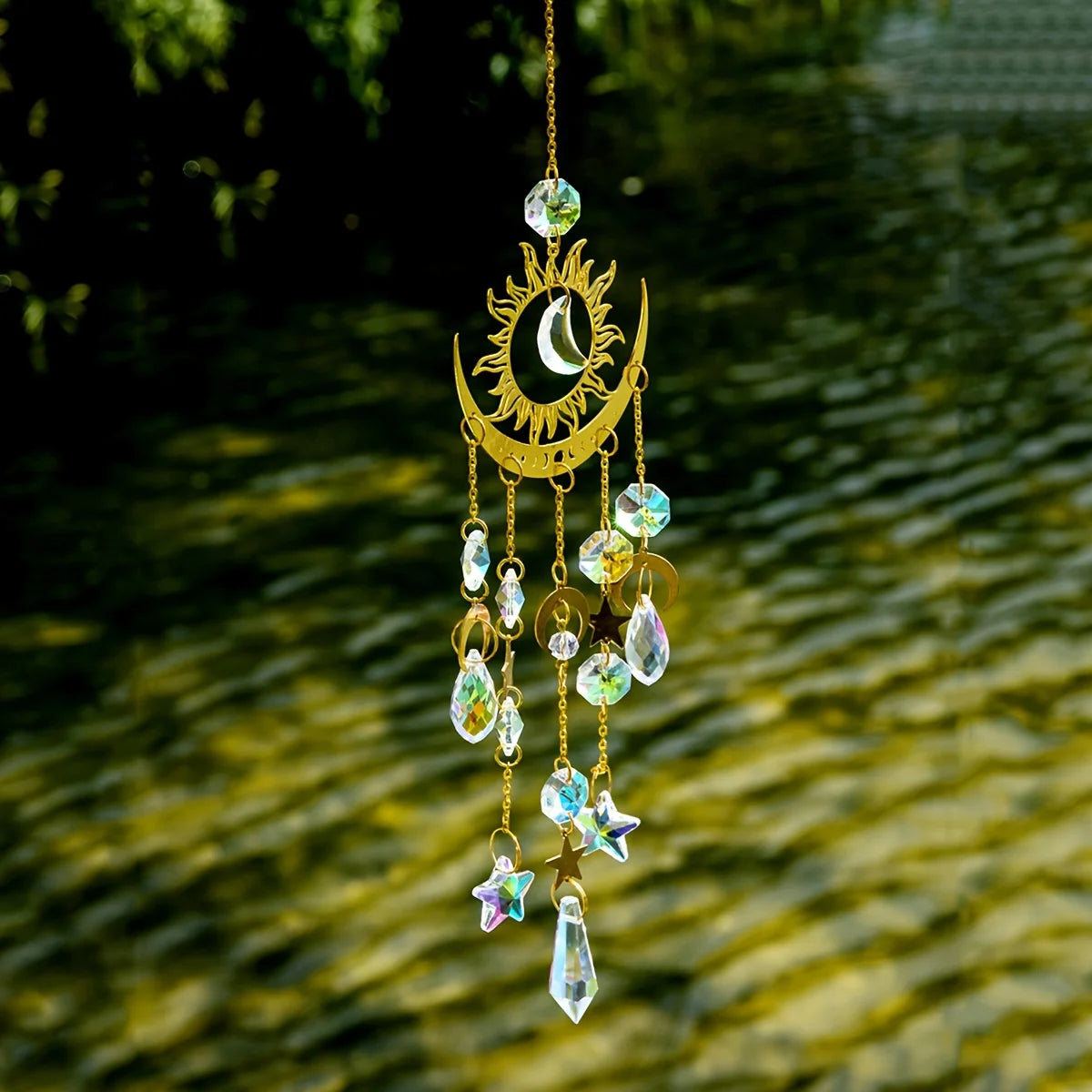 A hanging golden sun and crescent moon wind chime made of crystal beads.