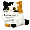Handmade crochet cat doll with black and white fur and a yellow knitted bat, featuring a positivity card.