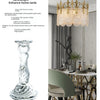 Elegant clear glass pillar candle holder displayed in a modern interior setting.