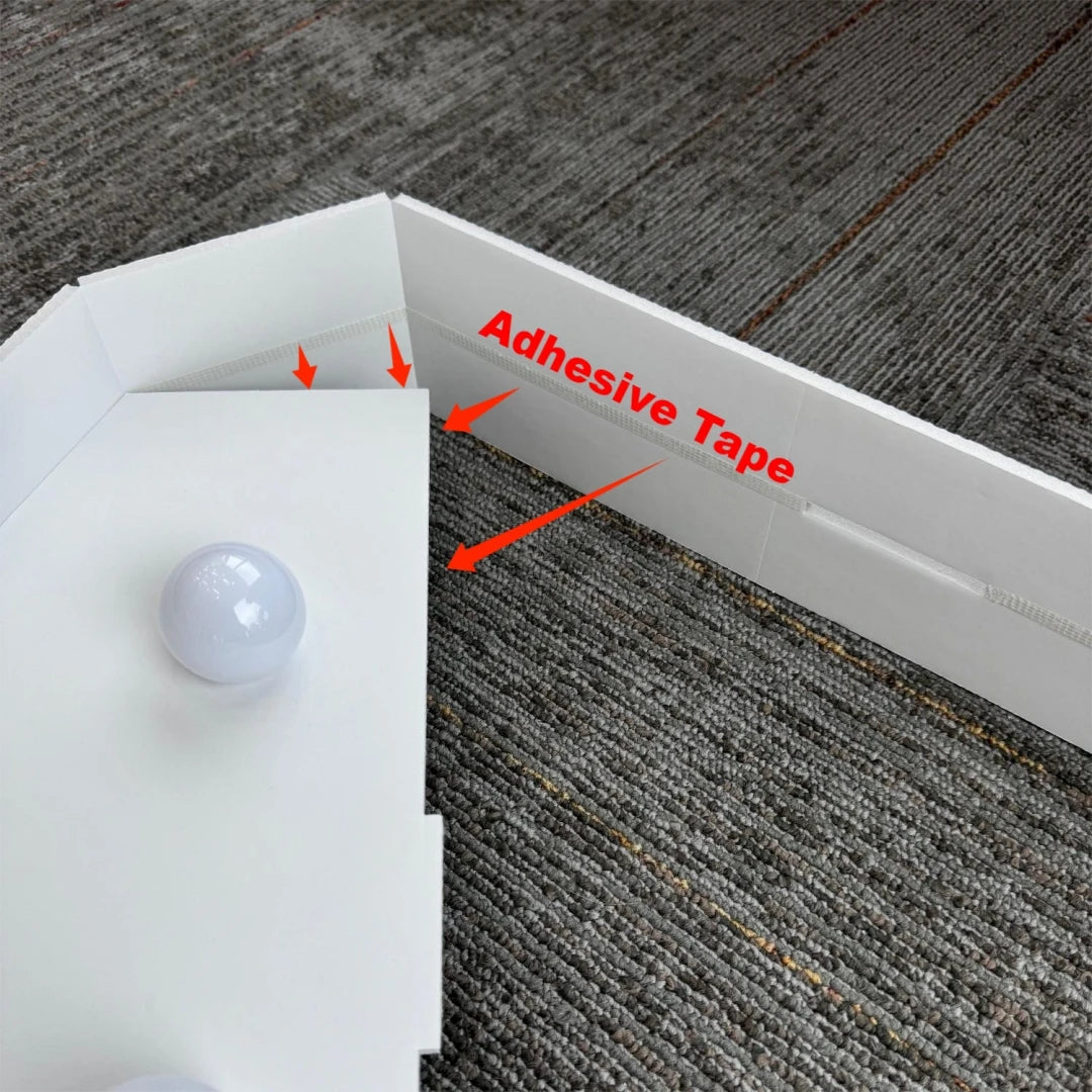 A white marquee light-up letter is shown with adhesive tape being applied to the back for mounting.