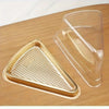A clear disposable plastic cake slice container resting on a wooden surface.