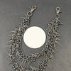 A heavy punk rivet biker style keychain featuring a chain of sharp metal spikes and rivets.