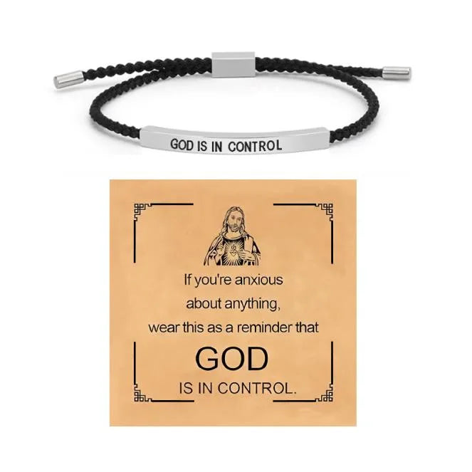 A stainless steel bracelet with a black cord and a tag that reads God is in control.