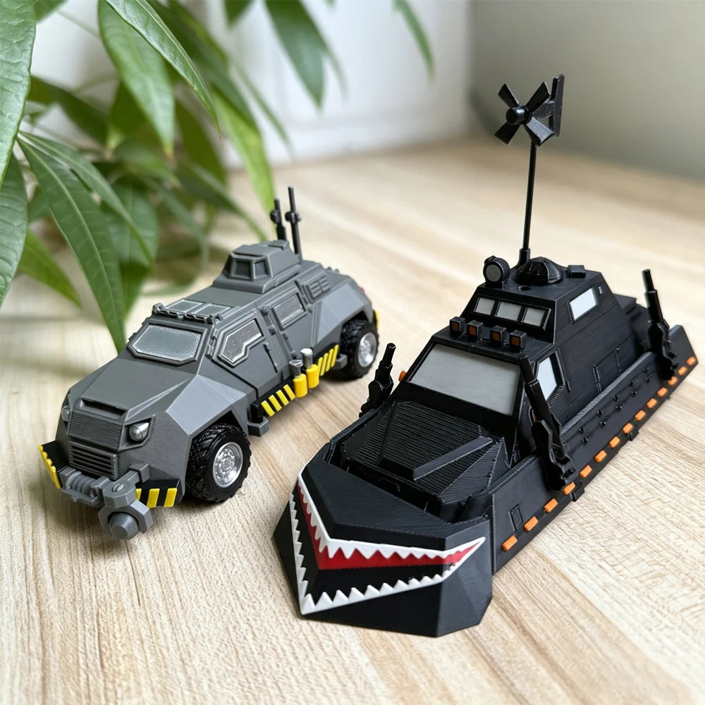 A black and gray armored car model resembling a Storm Chaser Tornado Interceptor displayed on a wooden surface.