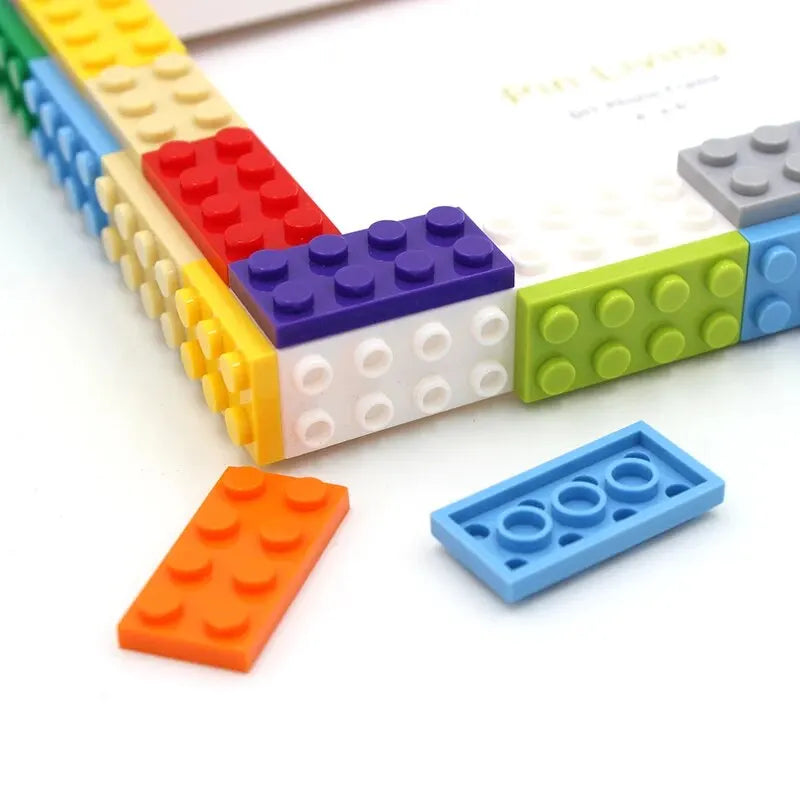 A colorful set of plastic building blocks in various colors arranged to form a photo frame.