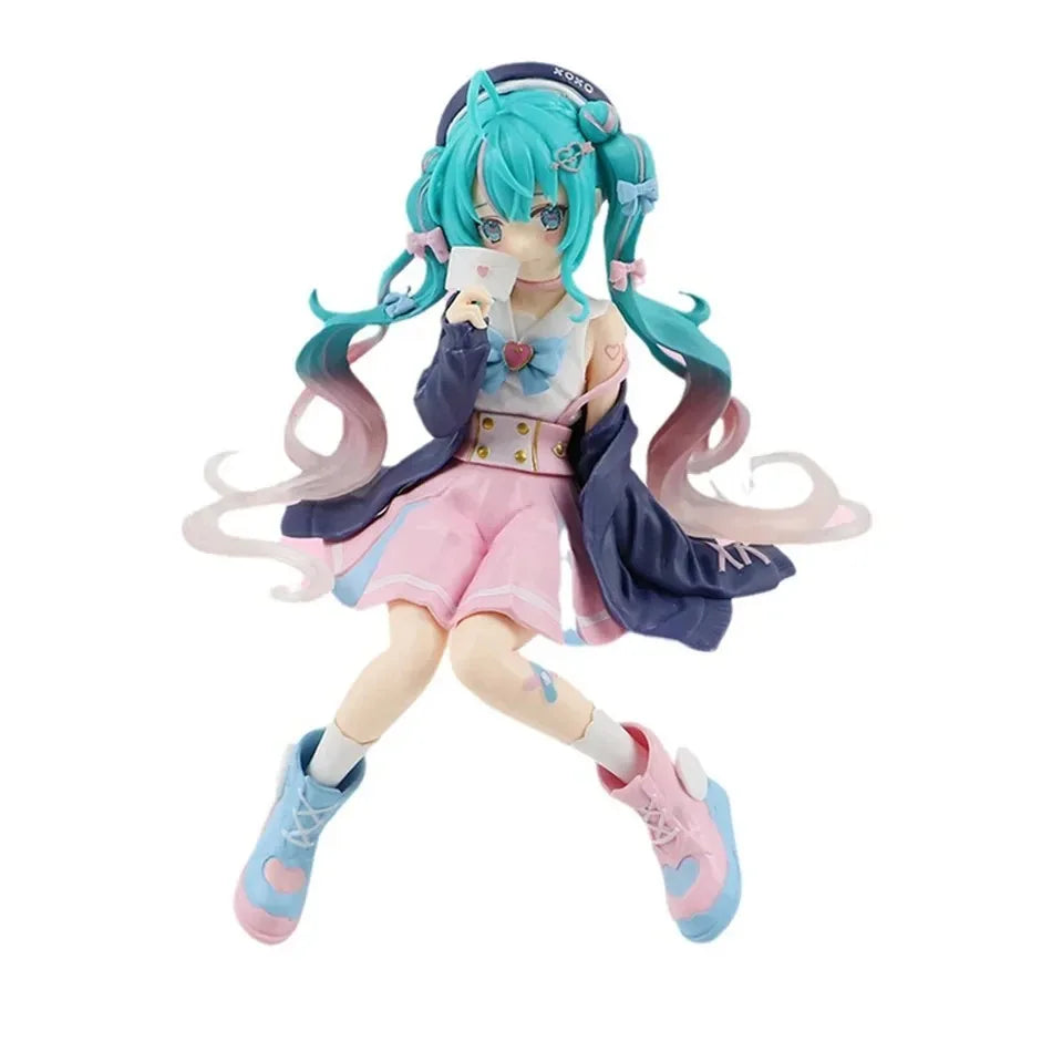 A figure of a Gothic Lolita Miku action fairy doll with teal hair and pink outfit holding a card.