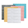 A collection of self-adhesive 3D brick wall panels in gray, yellow, pink, and light blue colors.