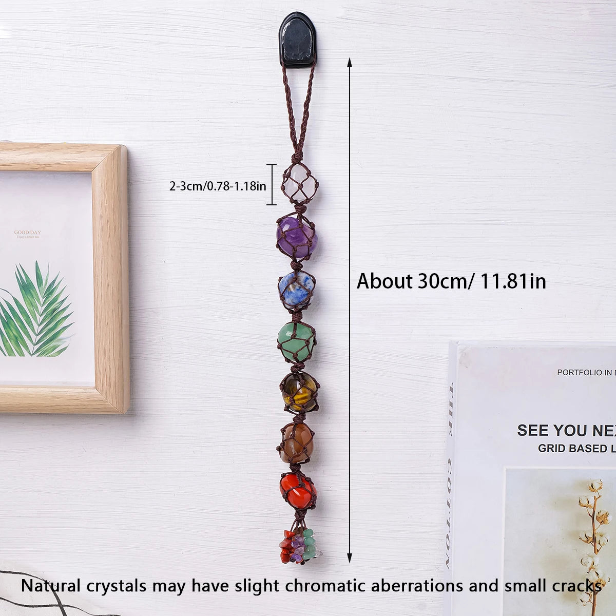 A long natural crystal pendant with a dark stone top and colorful tumbled crystals on a leather cord.